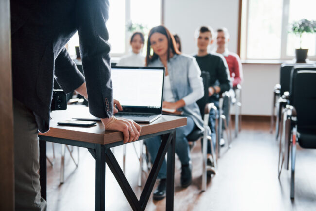 using-laptop-group-people-business-conference-modern-classroom-daytime