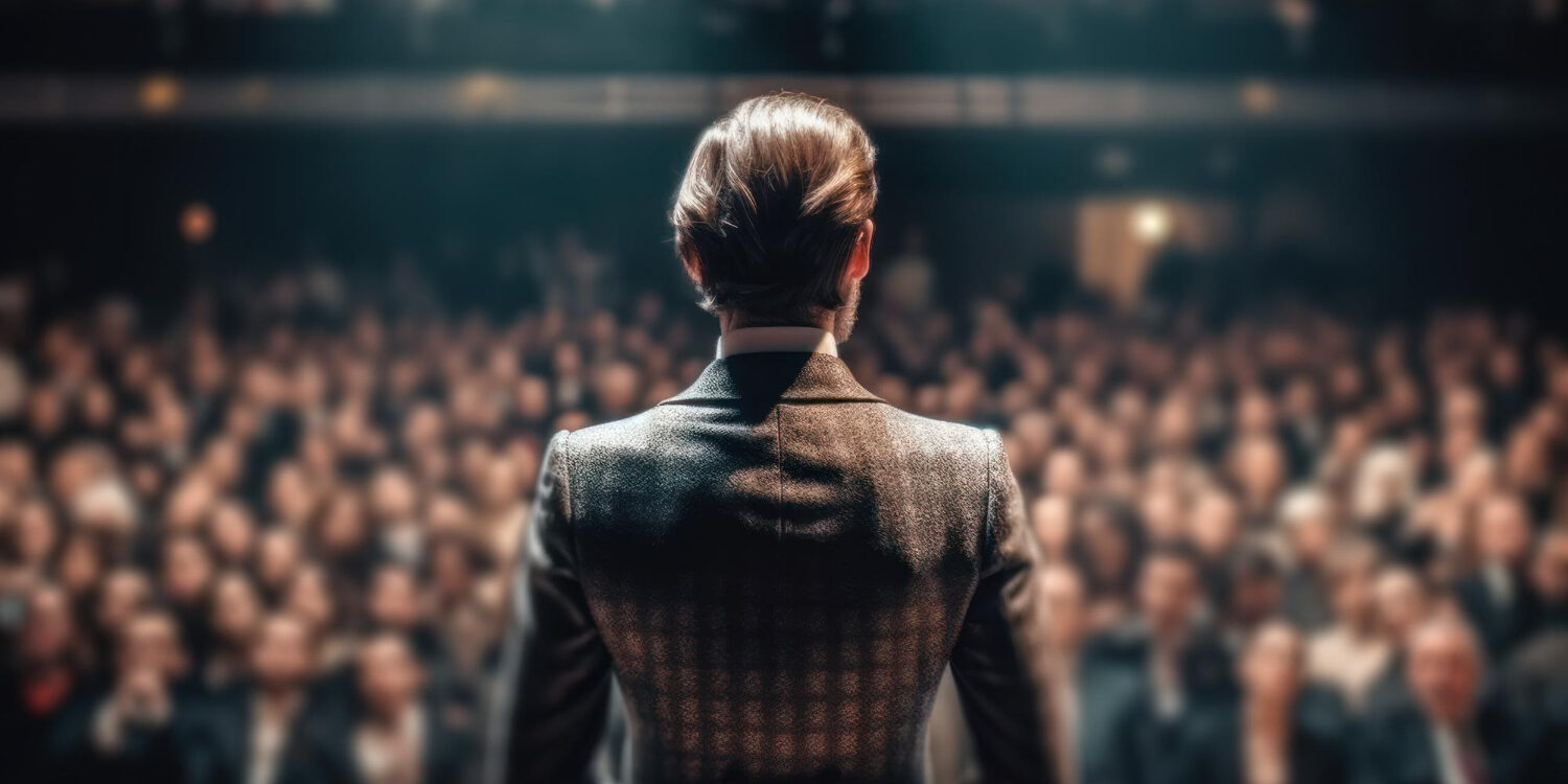 woman-speaks-large-audience-hall-presentation-business-training-generative-ai